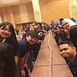 An energetic group of people looking into the camera together at an event